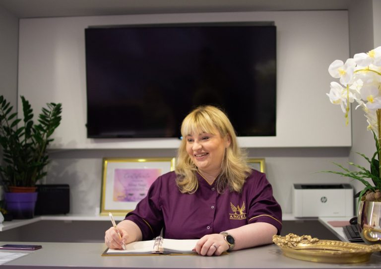 Women at a reception desk talking with client